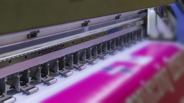 Large format inkjet printer printing with pink color on vinyl paper