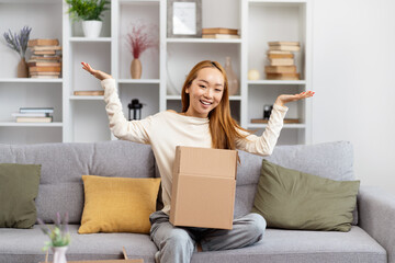 Happy Young Woman Unboxing Parcel In Living Room, Excited Female Sitting On Sofa, Lifestyle Home...