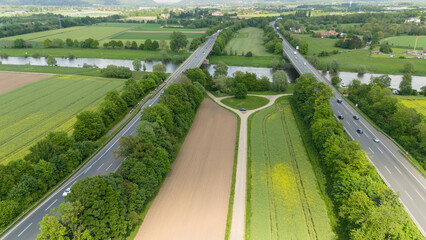 Two autobahns or highways over farm fields with corn and wheat. Drone beautiful view of Germany...