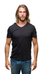 Fototapeta premium Young handsome man with long hair over isolated background with serious expression on face. Simple and natural looking at the camera.