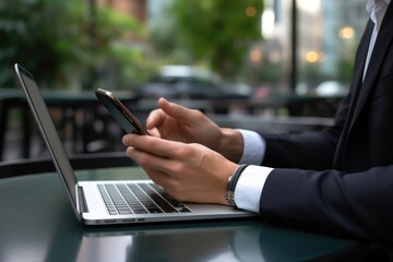 Fototapeta premium Man Using Laptop at a Table