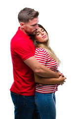 Naklejka premium Young couple in love over isolated background looking to side, relax profile pose with natural face with confident smile.