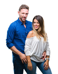 Fototapeta premium Young couple in love over isolated background winking looking at the camera with sexy expression, cheerful and happy face.