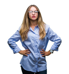 Young beautiful blonde business woman wearing glasses over isolated background winking looking at...