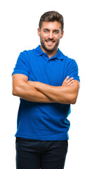 Obraz premium Young handsome man over isolated background happy face smiling with crossed arms looking at the camera. Positive person.