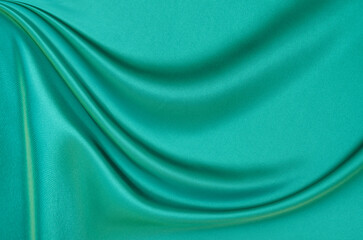 Black green satin dark fabric texture luxurious shiny that is abstract silk cloth background with...