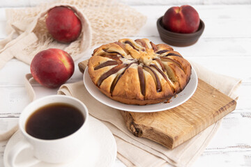 peach pie on a wooden table on a board and tea.The concept of breakfast.