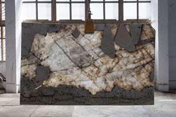 Picture of a marble slab on a hanger, shot in natural light, a cut of decorative marble in a...