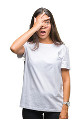 Fototapeta premium Young beautiful arab woman over isolated background peeking in shock covering face and eyes with hand, looking through fingers with embarrassed expression.