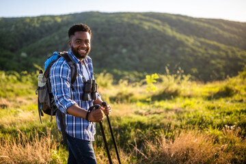 Young man enjoys hiking in nature.	