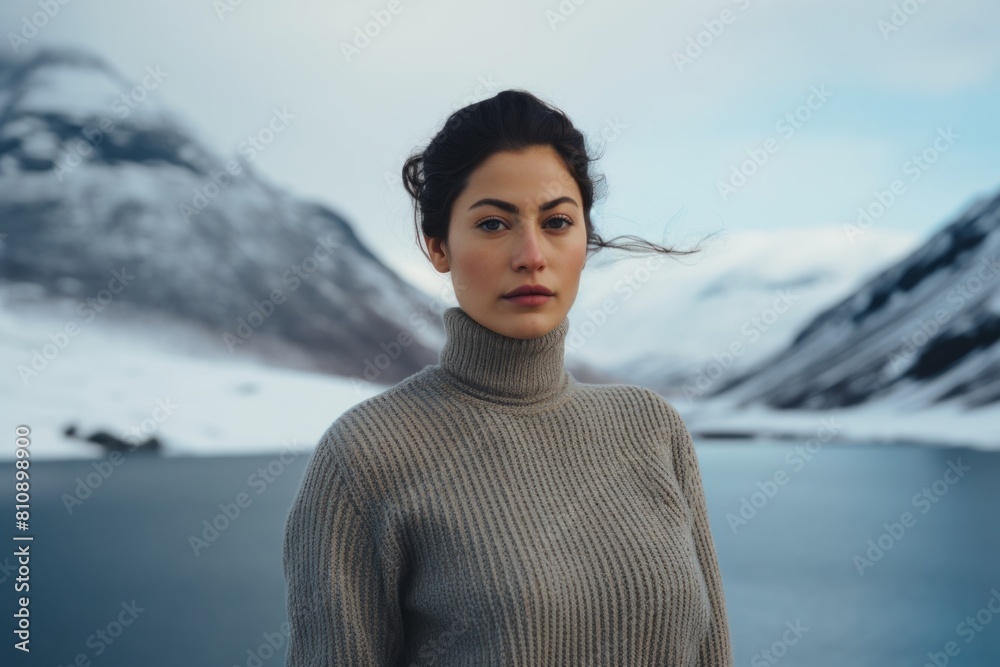 Wall mural Portrait of a merry woman in her 30s wearing a classic turtleneck sweater while standing against backdrop of an arctic landscape