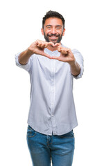 Adult hispanic man over isolated background smiling in love showing heart symbol and shape with hands. Romantic concept.