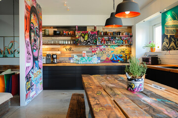 A contemporary Berlin kitchen, featuring clean lines, functional design, a graffiti art splashback,...