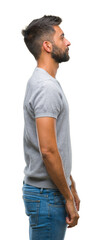 Fototapeta premium Adult hispanic man over isolated background looking to side, relax profile pose with natural face with confident smile.