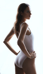 Fototapeta premium Confidence, serious and woman in bodysuit, studio and bikini for summer, aesthetic and clothes to relax. Swimsuit, proud and girl in white background, body and empowerment with fashion of shapewear