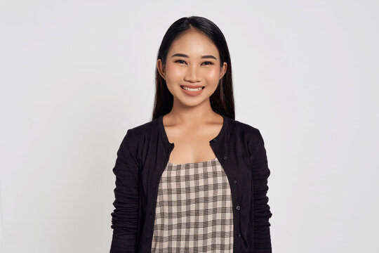 Portrait of a smiling beautiful Asian woman wearing casual shirt looking at camera with smile toothy isolated on white background. People lifestyle concept