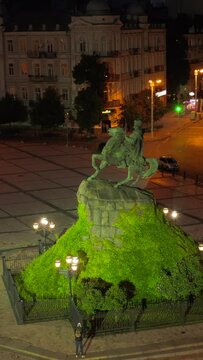 Vertical night aerial view of Bohdan Khmelnytsky Monument at Sophia Square in Kyiv, Ukraine.