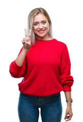 Young blonde woman wearing winter sweater over isolated background showing and pointing up with fingers number two while smiling confident and happy.