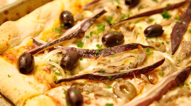 Pissaladi&egrave;re, a type of French pizza topped with onions, anchovies, and olives