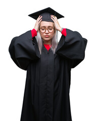 Young blonde woman wearing graduate uniform over isolated background suffering from headache desperate and stressed because pain and migraine. Hands on head.