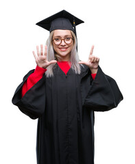 Young blonde woman wearing graduate uniform over isolated background showing and pointing up with fingers number seven while smiling confident and happy.