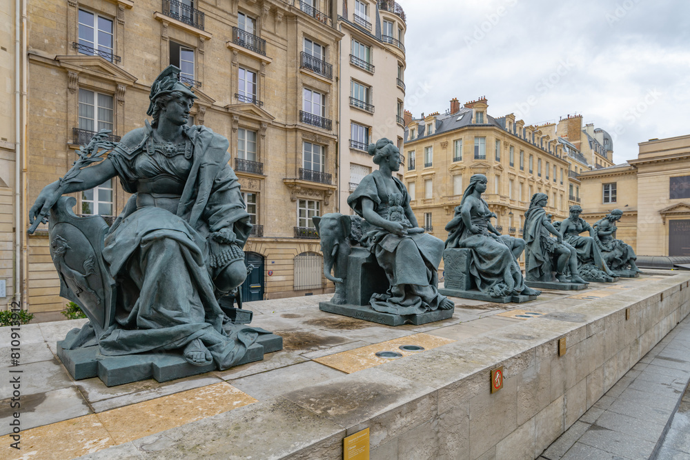 Wall mural a row of allegorical statues representing continents on the terrace of the orsay museum, with visito