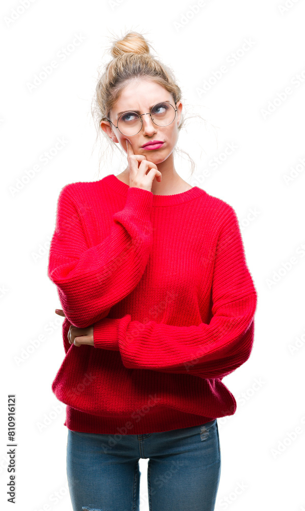 Sticker Young beautiful blonde woman wearing red sweater and glasses over isolated background with hand on chin thinking about question, pensive expression. Smiling with thoughtful face. Doubt concept.