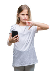 Fototapeta premium Young beautiful girl sending message texting using smarpthone over isolated background with angry face, negative sign showing dislike with thumbs down, rejection concept