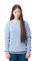 Young Chinese woman over isolated background depressed and worry for distress, crying angry and afraid. Sad expression.