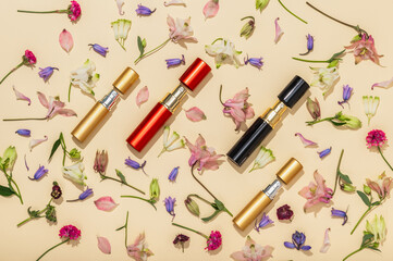 Atomizers with perfume on a spring floral background. Bright floral natural aromas.