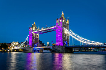 The Tower Bridge and the river Thames at night in London, UK