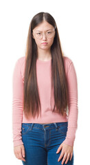 Young Chinese woman over isolated background wearing glasses skeptic and nervous, frowning upset because of problem. Negative person.