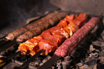 Close-up of an appetizing kebab or shashlik made of fresh meat and lula kebab is cooked on a...