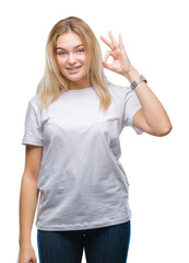 Young caucasian woman over isolated background smiling positive doing ok sign with hand and fingers. Successful expression.