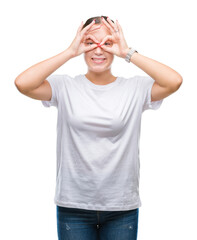 Fototapeta premium Young beautiful caucasian woman over isolated background doing ok gesture like binoculars sticking tongue out, eyes looking through fingers. Crazy expression.