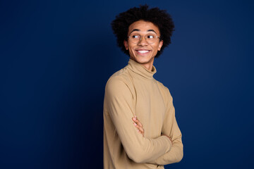 Photo portrait of nice young man look empty space crossed hands confident wear trendy beige outfit...