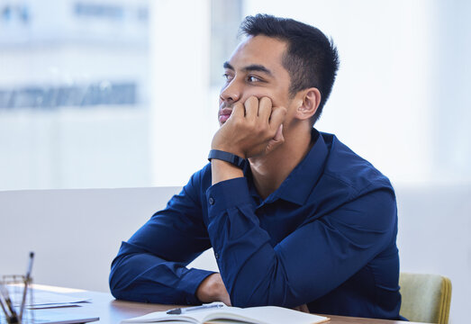 Business, man and thinking in office bored, desk and notebook for idea and vision for company or contemplating. Workplace, professional and distracted or daydreaming on job, employee and thoughtful