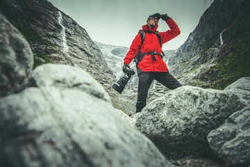 Caucasian Professional Nature Photographer with Digital Camera Preparing For the Shot