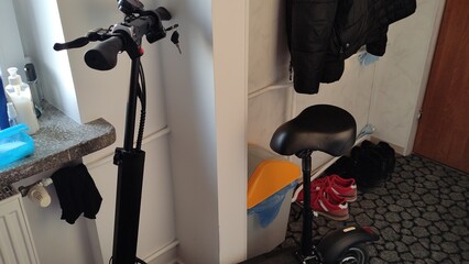 Electric scooter is charging in an apartment or in a student dorm room