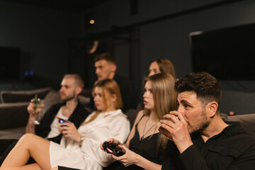 Women delve in thrill of video games surrounded by friends. Ladies demonstrate gaming proficiency and revel in camaraderie