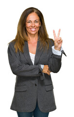 Middle age adult woman wearing oversize boyfriend jacket over isolated background smiling with...