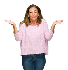 Beautiful middle age adult woman wearing winter sweater over isolated background clueless and...