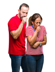 Middle age hispanic couple in love over isolated background feeling unwell and coughing as symptom for cold or bronchitis. Healthcare concept.