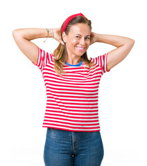 Beautiful middle age woman wearing casual stripes t-shirt over isolated background Relaxing and stretching with arms and hands behind head and neck, smiling happy