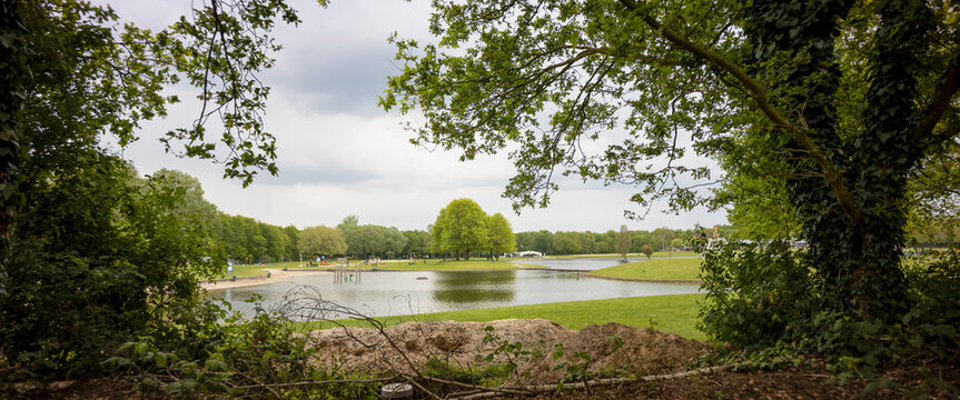 Framed panoramic landscape of recreational pond with picnic field and leisure area of Lageveld in Hoge Hexel