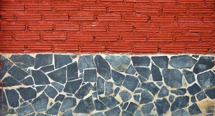 A brick wall with a red brick border and a blue brick border