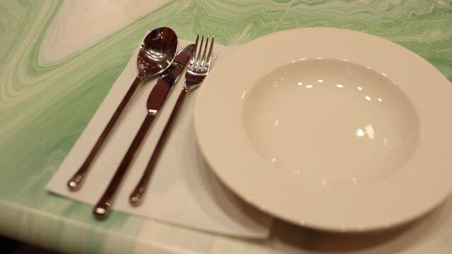 clean plate knife spoon fork on the kitchen table