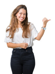 Young beautiful brunette business woman over isolated background smiling with happy face looking and pointing to the side with thumb up.