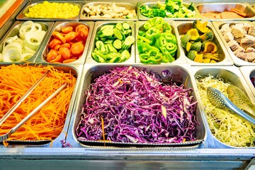 A tray of vegetables including carrots, broccoli, and cabbage