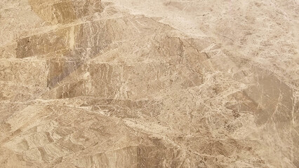 A beige marble surface, showcasing its intricate natural patterns
